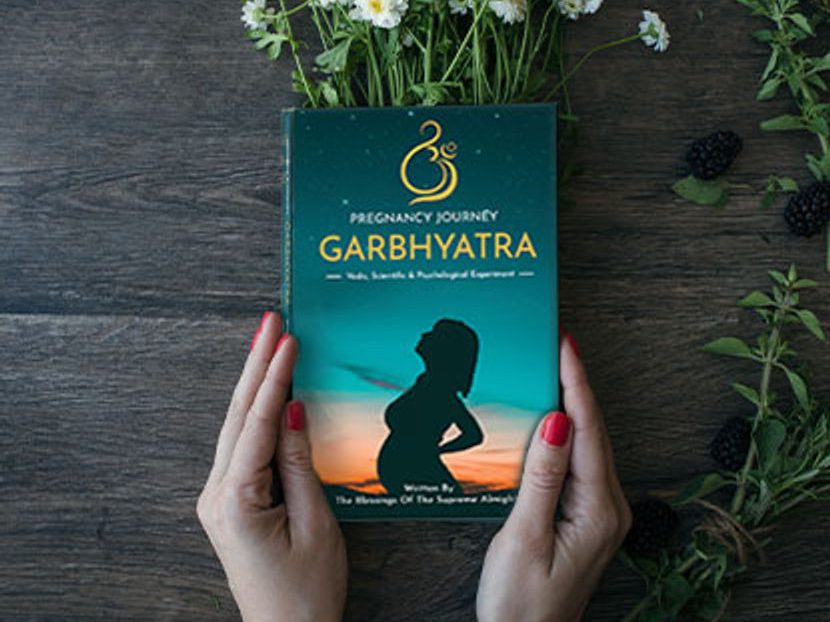The Garbh Yatra book, English edition, held in two hands