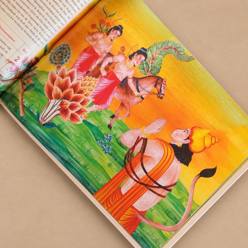 The open A4 book: a chaupai page beside a hand-painted picture